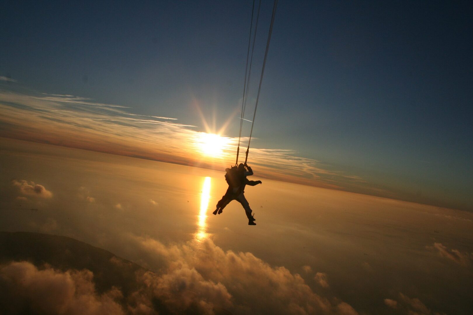 parachute jumping at sunset